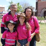 Family wearing pink work shirts